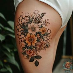 a woman's thigh with flowers and honeycombs on her side tattoo design