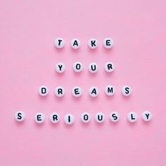 the words take your dreams seriously spelled in white letters on a pink background with an instagram post