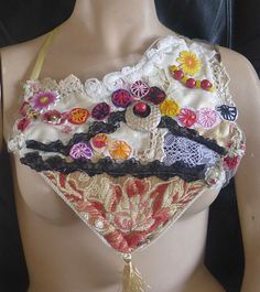 a woman's bra made out of fabric and buttons