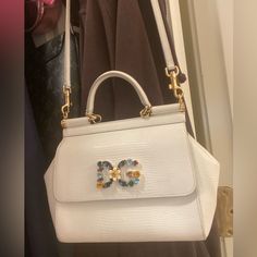 This Is A Gorgeous Authentic Dg Purse. I Used It For My Wedding And Absolutely Loved It. Have Matching Wallet For Sale Too. Comes With Dg Black Purse Bag. Reposhing This Item I Purchased From @Tenishataylo673. Loved It, But Ready To Rotate For Something New. Questions? Leave A Comment Below! Luxury Embellished White Bags, Luxury White Embellished Bag, Luxury White Embellished Bags, Designer Bags With Rhinestones For Everyday Use, Luxury Embellished Shoulder Bag For Shopping, Designer Embellished Bags For Shopping, Luxury Rhinestone Bags For Shopping, Luxury Embellished Crossbody Bag, Luxury Bags With Rhinestones