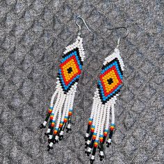 Tradicional Colors Native American Jewelry Beaded Earrings New. Native American Style Earrings American Indian Beaded Earrings American Pattern This Is A Lovely Pair Of Traditional Colors (White,Blue, Red, Yellow, And ,Black ) In Geometric Designs In Czech Beads. All Hand Made By Embera Indians. They Are Duster Earrings And Would Make A Great Gift Or To Treat Yourself They Measure 3.5 Inches In Length And 0.75 Inches Wide, Not Including The Ear Wires. White Beaded Earrings With Colorful Beads, White Earrings With Colorful Beads For Gift, White Drop Earrings With Dangling Beads, Traditional White Beaded Earrings With Ear Wire, White Beaded Earrings As Gift, White Dangling Beads Drop Earrings, Traditional White Beaded Earrings For Gift, Traditional White Beaded Earrings For Festivals, White Drop Earrings With Colorful Beads