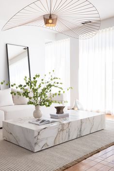 a marble coffee table in the middle of a living room