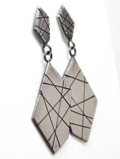 A modern play on sterling silver dangle earrings.  These earrings are hand made from recycled sterling silver sheet.  The design is sawed by hand and polished to a matte finish.  The silver has been oxidized to add depth and beauty.  Solid 925 Sterling SilverAbout 2" L x .75" WPost style with deluxe Luxlock Backs-Safe, Secure, ComfortableArtisan made in TexasThe earrings will arrive thoughtfully packaged in a signature jewelry box. Click here to see all of my earrings:  https://www.etsy.com/shop Modern Sterling Silver Nickel-free Linear Earrings, Modern Nickel-free Sterling Silver Linear Earrings, Handmade Sterling Silver Geometric Jewelry, Handmade Geometric Sterling Silver Jewelry, Modern Handmade Long Drop Linear Earrings, Modern Soldered Sterling Silver Earrings, Modern Geometric Sterling Silver Earrings, Modern Silver Linear Earrings As Gift, Silver Geometric Pierced Earrings