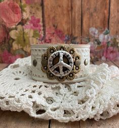 v'¯) .`*.¸.*' ★ Leather cuff bracelet, always with a FeMiNinE flair ❤ This DESIGN ~ ❤ This silver peace sign concho and exquisite brass flower filigree sits on tooled leather that was hand painted in cream. Distressed to show all the details. BRACELET SIZING INFO: My women's bracelets are approximately 8 1/2 inches end to end. I place 2 snaps at 7 and 7 3/4 inches for adjustability. jewelry for your heart & soul <-----❤---- Vintage Handmade Adjustable Wristband, Handmade Adjustable Vintage Wristband, Handmade Vintage Adjustable Wristband, Vintage Adjustable Cuff Wristband, Vintage Adjustable Wristband Bracelet, Adjustable Vintage Wristband Bracelet, Adjustable Vintage Wristband, Adjustable Cream Cuff Bracelet Gift, Adjustable Cream Cuff Bracelet As Gift