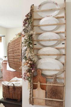 a wooden shelf with plates and utensils on it