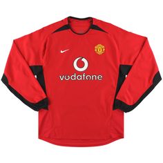 the manchester united home shirt is shown in red and black, with an emblem on it