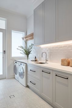 a washer and dryer in a white kitchen