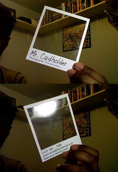 a person holding up a card in front of a mirror