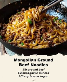 a skillet with noodles and beef in it