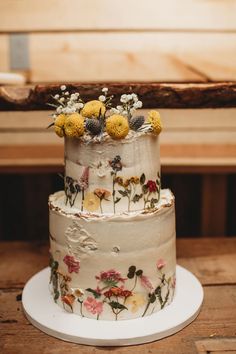 a three tiered cake with flowers on it