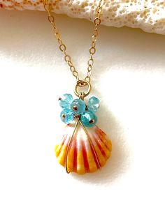 "Genuine Hawaiian sunrise seashell with pale blue aquamarine gemstones wire wrapped on 14k gold fill chain necklace.  Rare petite 5/8\" Hawaiian sunrise shell found in deep waters off island of Oahu. Shell is beautiful colors of yellow pink and white and carefully wire wrapped with natural blue 4mm aquamarine rondelles. Little shell hangs from dainty 14k gold fill cable chain with spring ring clasp. Total pendant drop is 1\".  Necklace length is 18\".  You will receive this exact sunrise shell. Ocean-inspired Wire Wrapped Shell, Ocean-inspired Shell Jewelry With Wire Wrapped Detail, Wire Wrapped Shell Jewelry With Ocean-inspired Style, Ocean-inspired Shell Jewelry With Wire Wrapping, Ocean-inspired Shell Jewelry Wire Wrapped, Ocean-inspired Shell Wire Wrapped Jewelry, Washed Up On Shore, Sunrise Shell, Seashell Necklace