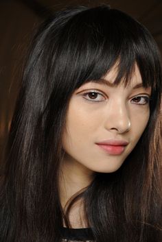 a woman with long black hair and brown eyes