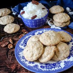 several cookies on a blue and white plate with pecans in the background, along with other desserts