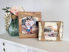 two wooden frames sitting on top of a dresser next to a vase filled with flowers