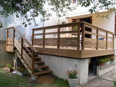 there is a wooden staircase going up the side of this house