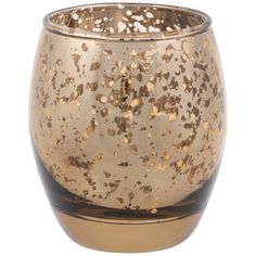 a gold and black glass candle holder on a white background with lots of speckles