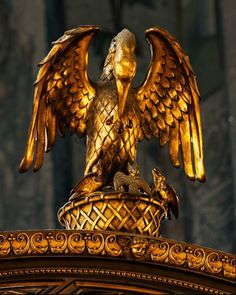 a golden statue with an eagle sitting on top of it