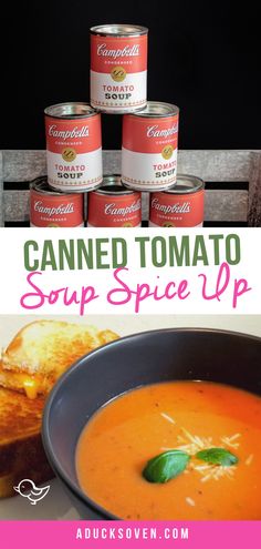 canned tomato soup in a black bowl with basil leaves on top and four cans next to it