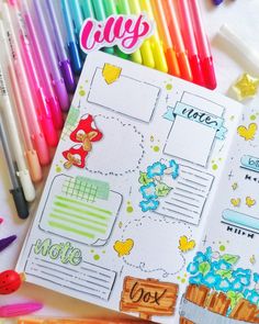 an open planner with colorful markers and pens