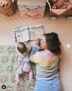 a mother reading to her baby on the floor