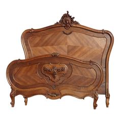 an ornate wooden bed frame with carved details