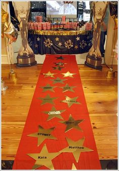 a long red table runner with gold stars on it in front of an american flag