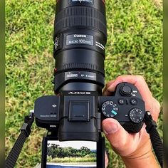 a person holding up a camera in their hand