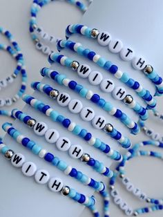 blue and white bracelets with words that spell out the word witt on them