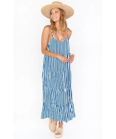 This favorite strappy dress is now in a maxi length! The Caroline Maxi Dress is a vacation must have with her breezy blue and white striped fabric, adjustable straps, and perfectly tiered flow! Product Details *Lightweight drapey fabric - 100% Polyester*Adjustable straps*53" from shoulder to hem Model & Fit Sophia is 5'9 and wearing size x-large / Bri is 5'8" and wearing size small Striped Maxi Sundress For Vacation, Striped Summer Maxi Dress For Vacation, Summer Striped Maxi Dress For Vacation, Striped Sundress Maxi Dress For Beach Season, Striped Sundress With Spaghetti Straps For Beach, Striped Sundress For Vacation, Striped Tiered Dresses For Vacation, Striped Tiered Dress For Vacation, Striped Sleeveless Sundress For Vacation