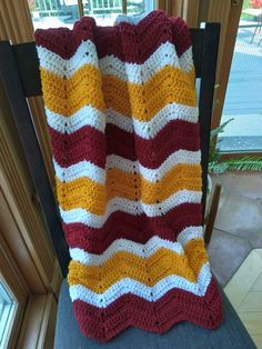 a crocheted blanket sitting on top of a chair