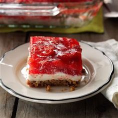 a piece of cake sitting on top of a white plate next to a glass container