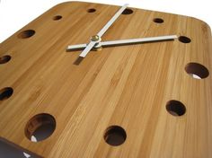 a clock made out of wood with holes in it