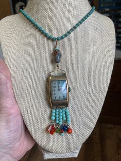 "~ I made this set and fell in love with it. It is one of my favorite pieces. It is made of an vintage (man's) watch face (non working). Inside the watch is patina, which is a green color and was the inspiration in my color choices. I added clear seed beads and a beautiful art glass bead at the top. All the beads are vintage and glass. On the bottom of the necklace I hung several turquoise colored beads and a different color and kind off each section. The chain is also vintage, maybe from the 80 Adjustable Necklace With Large Beads Of Recycled Glass, Vintage Glass Jewelry With Beaded Chain, Recycled Glass Bead Necklace, Adjustable Beaded Recycled Glass Necklace, 1950s Man, Green Beaded Recycled Glass Necklace, Face Necklace, Metal Ball, Assemblage Jewelry