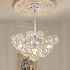 a chandelier hanging from the ceiling in a room