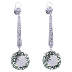 Green Amethyst Brilliant Cut Round Prasiolite Diamond Drop Line Unique Statement Classic Timeless 18K White Gold Dangle Earrings 18 Karat White Gold Genuine Green Amethyst/Prasiolites & Diamonds 16.71 CT Green Amethyst Gemstones 0.53 CTW Diamonds Beautiful light green color - almost transparent in brilliance with hints of slight light green hues of forests, fields & mints. Some have commented that these stones remind them of the Mediterranean Sea of Greece & Balkan coasts. Extremely aqua teal green. Stunning pair of earrings crafted in white gold for a classic, timeless look & ready-to-wear for any occasion, especially for evening & formal wear. American Art Deco, Light Green Color, Gold Dangle Earrings, White Gold Earrings, Evening Formal, Earring Crafts, Diamond Drops, Green Amethyst, Mediterranean Sea