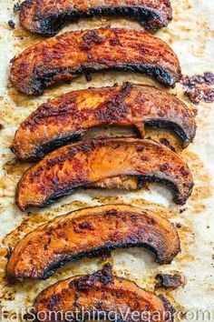 grilled sausages are lined up on a baking sheet