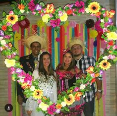 a group of people standing next to each other in front of a heart shaped frame