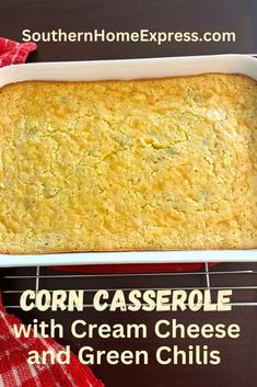 corn casserole with cream cheese and green chilis in a white baking dish