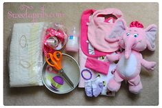 an assortment of baby items are laid out on the floor with scissors and other accessories