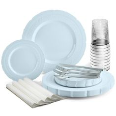 a table setting with plates, silverware and napkins