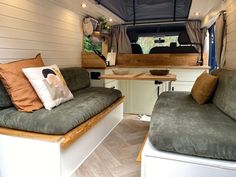 the interior of a camper with two couches