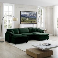 a living room filled with furniture and a large painting hanging on the wall above it