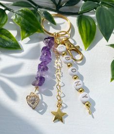 the keychain is decorated with beads and charms that spell out love, peace, and star