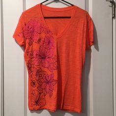 V-Neck Coral Orange T-Shirt With Pink Hibiscus Flowers Pink V-neck Graphic Tee Top, Pink V-neck Graphic Tee, Orange V-neck T-shirt For Summer, Pink Cotton V-neck T-shirt, Pink Hibiscus, Orange T Shirt, Orange T Shirts, Coral Orange, Hibiscus Flowers