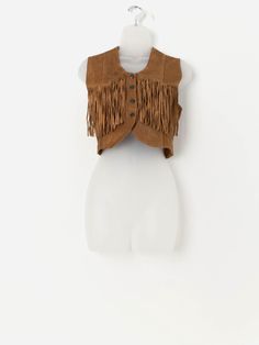 90s vintage fringed cropped suede waistcoat in tan. This 90s/Y2K tan suede vest features a snap button closure, a V-neck and a beautiful fringe detail just below the chest. Made from a mid-weight butter soft suede. Our recommended size: Medium Label says: Medium Condition: Good* Some fringe missing on the left. Please see last image (not colour accurate) Material: 100% suede Measurements in inches: Pit to pit: 18.5 Shoulders: 14 Front length: 15.5 Back length: 16.5 Hem: 15.5 *Imperfections, scar Suede Waistcoat, Vintage Fringe, Suede Vest, Vest Outfits, Tan Suede, 90s Vintage, Soft Suede, Snap Button, Favorite Outfit