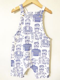 This overall romper is the perfect outfit - great in warmer weather on it's own or in cooler weather layered over a shirt. We make this one out of super soft organic cotton knit with an awesome hipster sailor print on it and include gold snaps for the fasteners. It is partially lined on the top. Diaper changes are so easy - just unsnap two snaps and pull the whole thing down. Much easier than snaps at the inseam on a squirmy baby! F A B R I C This romper features 100% organic cotton knit fabric Spring Cotton Bubble Romper With Pockets, Printed Cotton Onesie For Playwear, Summer Cotton Printed Bubble Romper, Cute Bib Front Overalls For Summer, Summer Cotton Overalls For Playwear, White Printed Jumpsuits And Rompers For Playwear, Playful Cotton Overalls For Playwear, Casual Organic Cotton Onesie For Summer, Spring Cotton Onesie With Graphic Print