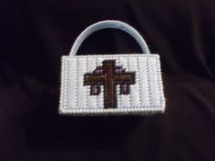 a small purse with a cross on it