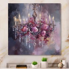 a chandelier with pink flowers and candles hanging from it's centerpiece