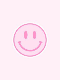 a pink smiley face sticker on a white background