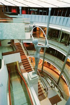 an escalator with a statue on it in a building